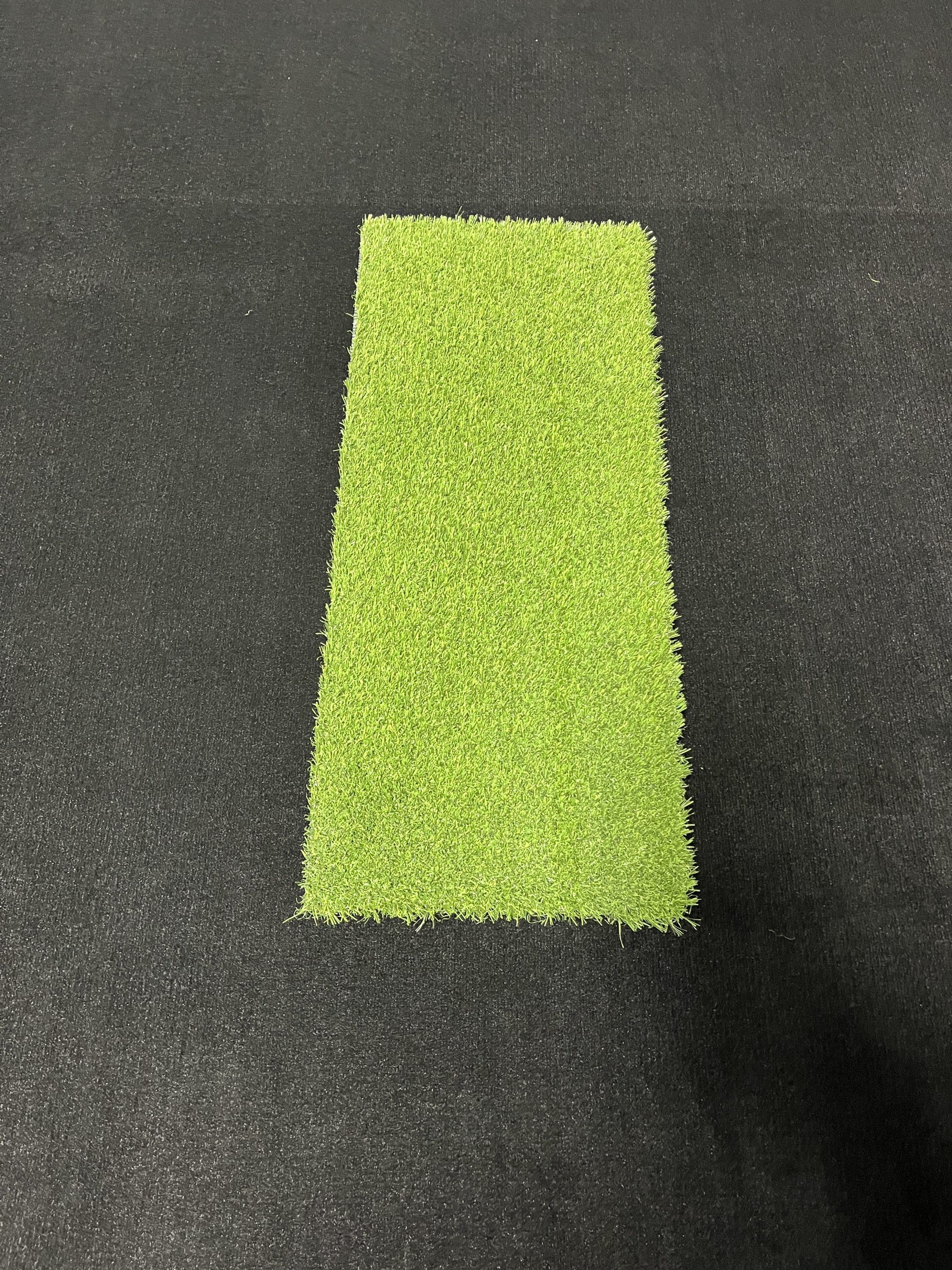 Golfer hitting off Big Moss Pure Flight Premium Hitting Strip