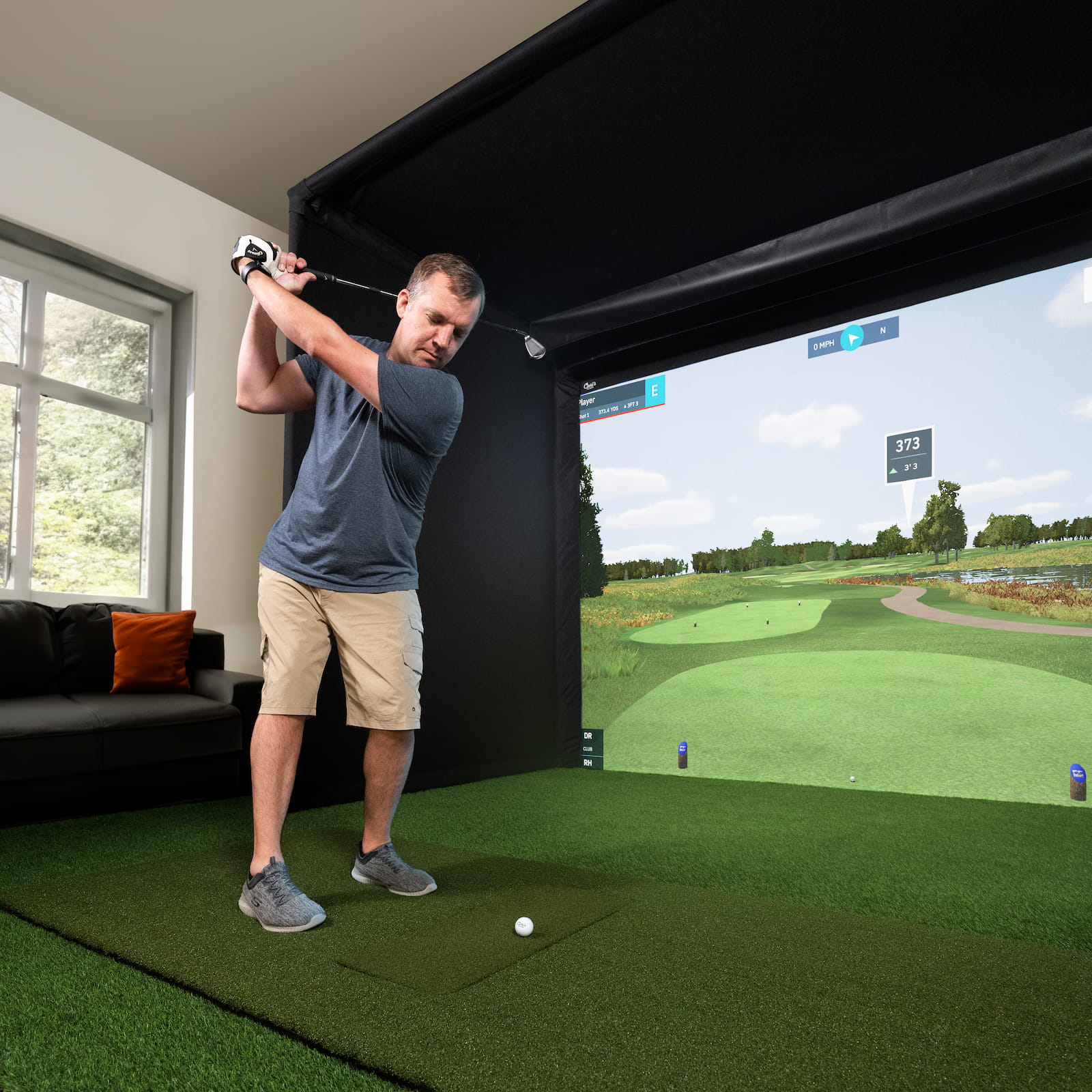 Golfer using the Carls Pro simulator enclosure